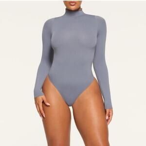 Skims Essential Mock Neck Long Sleeve Bodysuit in the color Onyx